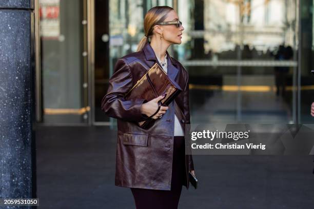 Viktoria Rader wears burgundy blazer, pants, bag, sunglasses, white button shirt outside Zimmermann during the Womenswear Fall/Winter 2024/2025 as...