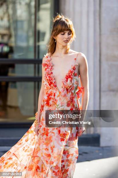 Justine Soranzo wears red white v neck ruffled dress with floral print in red white orange outside Zimmermann during the Womenswear Fall/Winter...