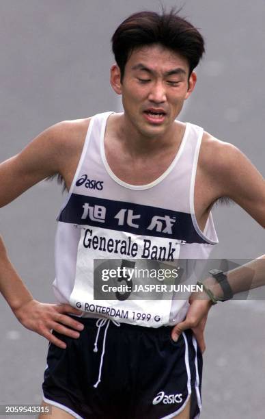 Best Japanese runner Muneyuki Ojima, 18 April 1999, stands exhausted with his eyes closed after finishing the 1999 Rotterdam Marathon in sixth...