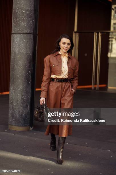 Mary Leest is seen wearing a brown cropped jacket, cropped pants, belt, black bag and button shirt in beige outside Zimmermann during the Womenswear...