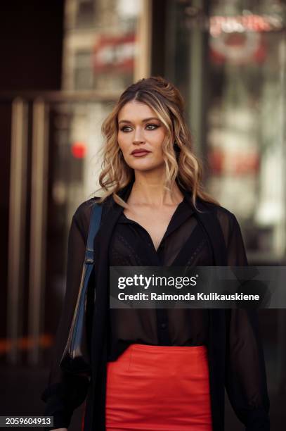 Chloe Lecareux is seen wearing a black transparent top, red skirt and black bag outside Zimmermann during the Womenswear Fall/Winter 2024/2025 as...