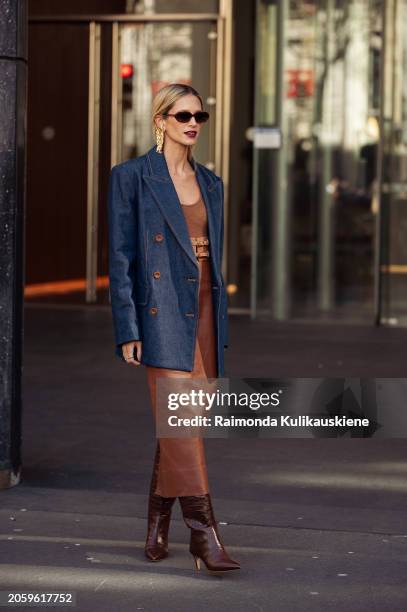 Helena Bordon is seen wearing a denim blazer, golden earrings and brown top, brown leather skirt and brown shoes outside Zimmermann during the...