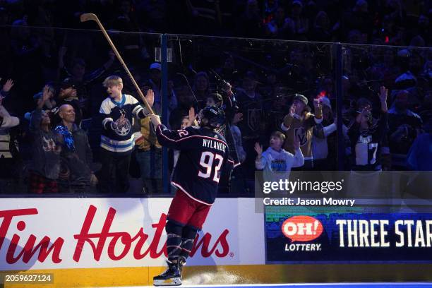 First Star of the game Alexander Nylander of the Columbus Blue Jackets hands a stick over the glass after the game against the Vegas Golden Knights...