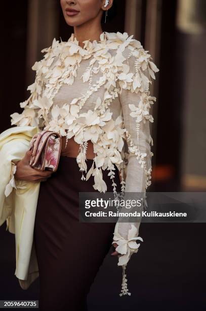 Guest is seen wearing white top decorated with flowers, brown maxi skirt, pink bag with floral print outside Zimmermann during the Womenswear...