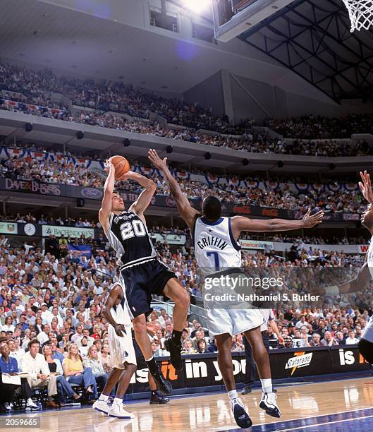 Emanuel Ginobili of the San Antonio Spurs puts up a jump shot against Adrian Griffin of the Dallas Mavericks in Game Six of the Western Conference...