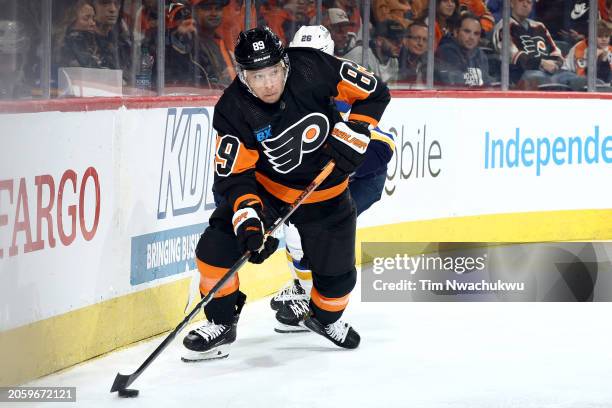 Cam Atkinson of the Philadelphia Flyers skates with the puck past Nathan Walker of the St. Louis Blues during the third period at the Wells Fargo...