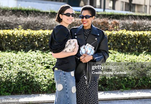 Erika Boldrin is seen wearing a black top, blue and white patch jeans and black sunglasses with Tamu McPherson wearing a black biker jacket, black...
