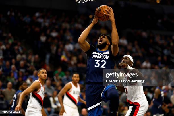 Karl-Anthony Towns of the Minnesota Timberwolves goes up for a shot against the Portland Trail Blazers in the third quarter at Target Center on March...