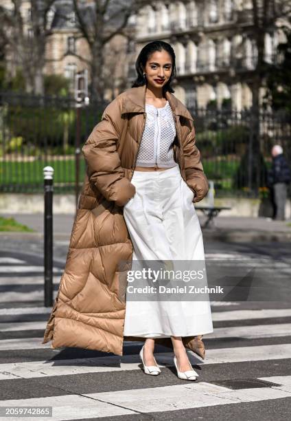Malvika Sheth is seen wearing a tan puff Shiatzy Chen coat, white Shiatzy Chen top and pants and Roger Vivier shoes outside the Shiatzy Chen show...