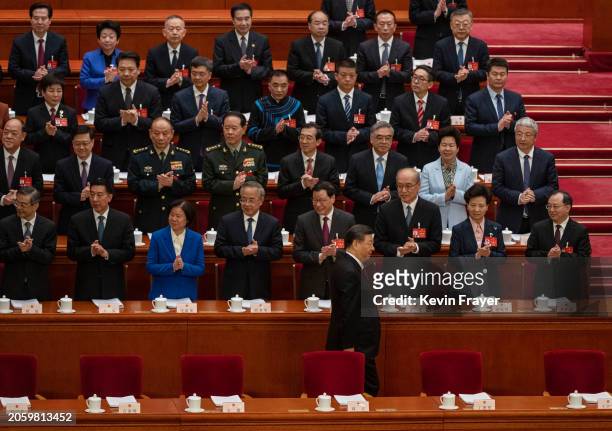 Chinese President Xi Jinping is applauded by delegates and senior leaders as he arrives at the opening of the NPC, or National People's Congress, at...