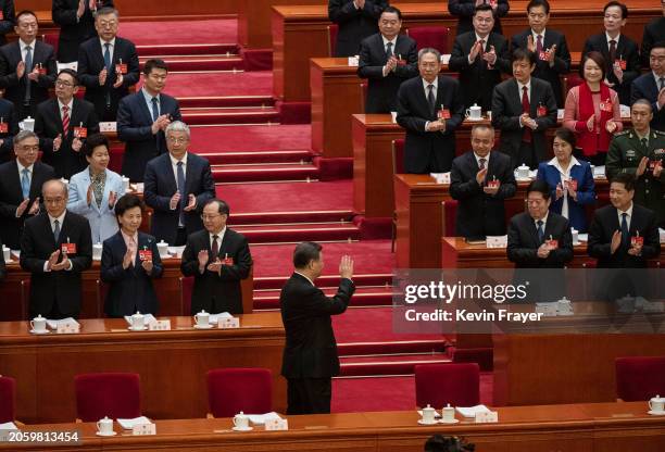 Chinese President Xi Jinping waves to delegates and senior leaders as he arrives at the opening of the NPC, or National People's Congress, at the...