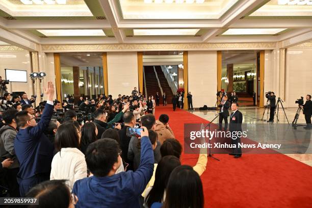 Chinese Minister of Agriculture and Rural Affairs Tang Renjian gives an interview after the opening meeting of the second session of the 14th...