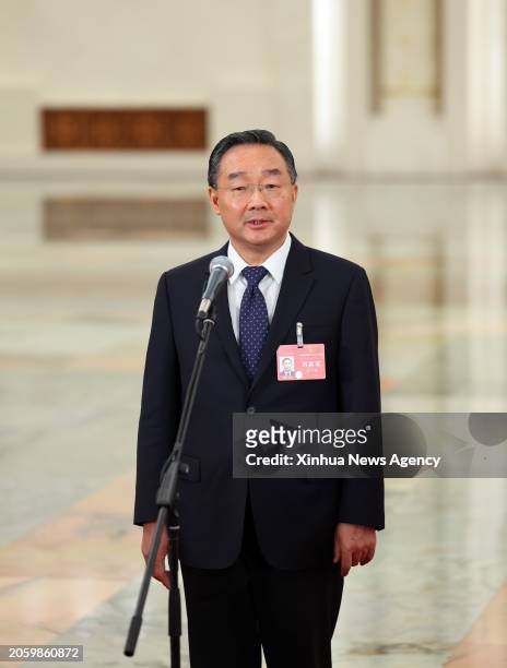 Chinese Minister of Agriculture and Rural Affairs Tang Renjian gives an interview after the opening meeting of the second session of the 14th...