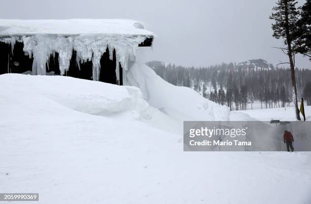 Person walks at Boreal Mountain Resort, currently shuttered due to the snowstorm, following a massive snowstorm in the Sierra Nevada mountains on...