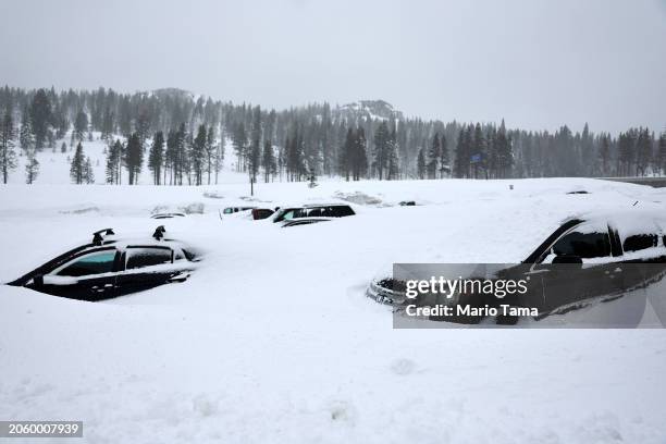 Vehicles are covered in snow at Boreal Mountain Resort, currently shuttered due to the storm, following a massive snowstorm in the Sierra Nevada...