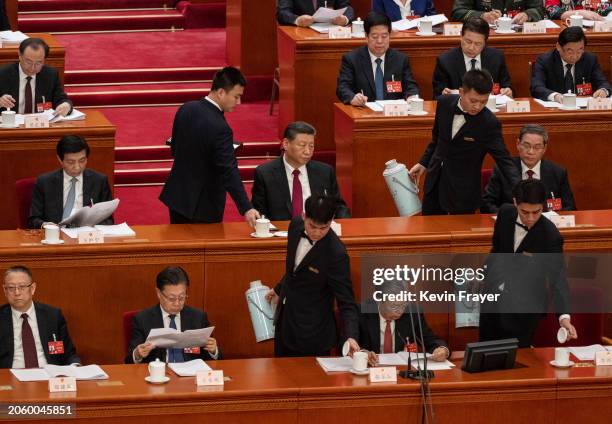 Chinese President Xi Jinping and Premier Li Qiang are served tea by hosts at the opening of the NPC, or National People's Congress, at the Great Hall...