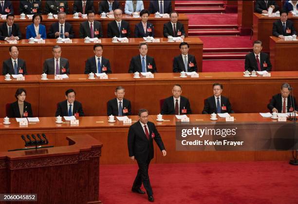 Chinese Premier Li Qiang walks on the stage before his speech at the opening of the NPC, or National People's Congress, at the Great Hall of the...