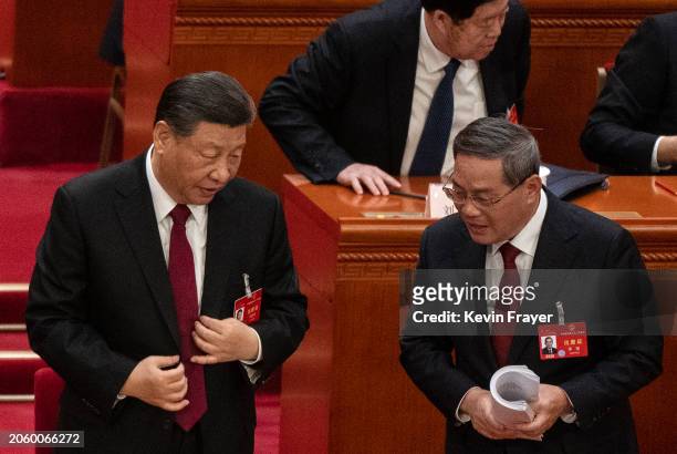 Chinese President Xi Jinping speaks to Premier Li Qiang at the opening of the NPC, or National People's Congress, at the Great Hall of the People on...
