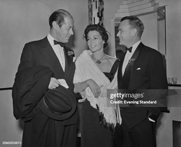 Actor Rex Harrison , with his wife, German actress Lilli Palmer , and actor John Mills attending an event, September 25th 1953.