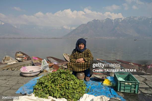 Vegetable seller waits for customers at a street market in Srinagar on March 8, 2024.