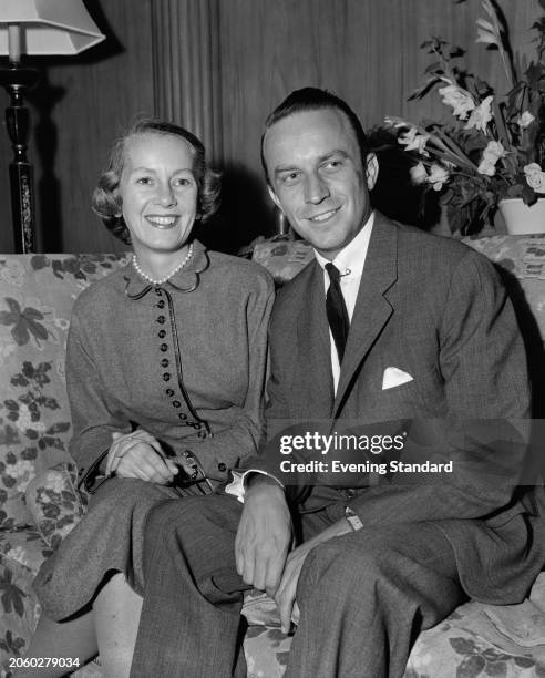 American politician Herbert Hoover Jr , US Under Secretary of State, seated on a sofa with his wife Margaret , September 12th 1955.