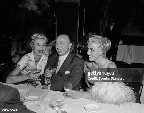 American actress Irène Hilda , French costume designer Michel Gyarmathy and English singer Yana attending an event, September 7th 1955.