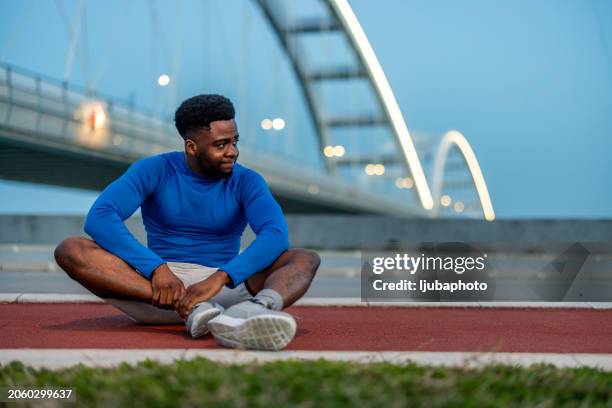 young adult male with his muscle pain during running. runner man having leg ache due to ankle sprains or achilles tendonitis. - achilles stock pictures, royalty-free photos & images