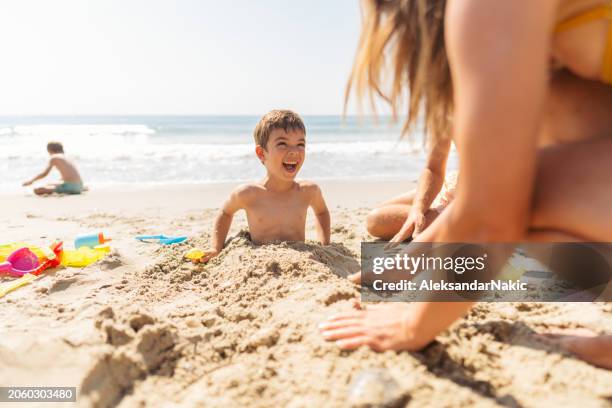 fun afternoon at the beach - bury stock pictures, royalty-free photos & images