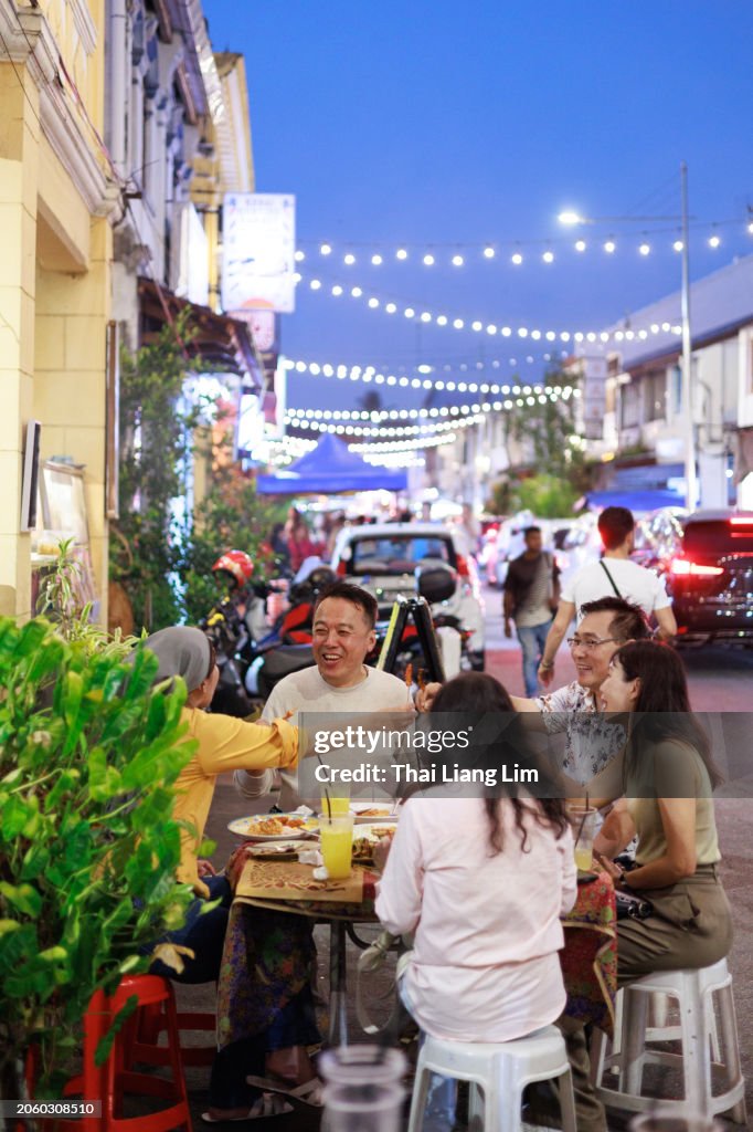 A diverse group of friends delighting in tasty street food adventures together.