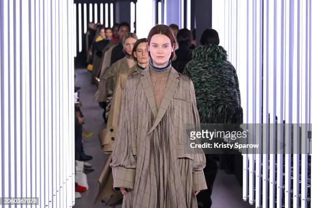 Jac Jagaciak walks the runway with models during the Sacai Womenswear Fall/Winter 2024-2025 show as part of Paris Fashion Week on March 04, 2024 in...