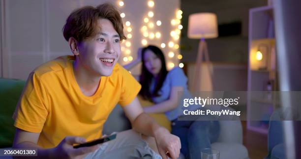 asian couple watch tv home - streaming service stock pictures, royalty-free photos & images