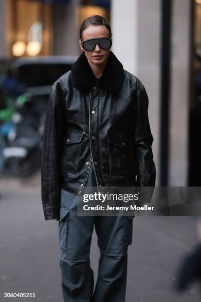 Guest seen wearing Loewe black mirrored sunglasses, Diesel black oversized leather jacket with black fake fur collar, Coperni grey cargo pants,...