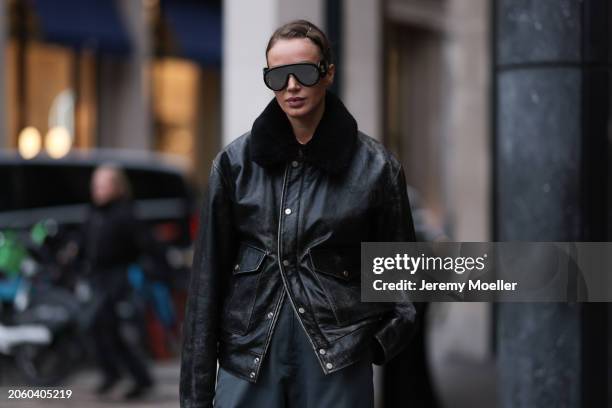 Guest seen wearing Loewe black mirrored sunglasses, Diesel black oversized leather jacket with black fake fur collar, Coperni grey cargo pants,...