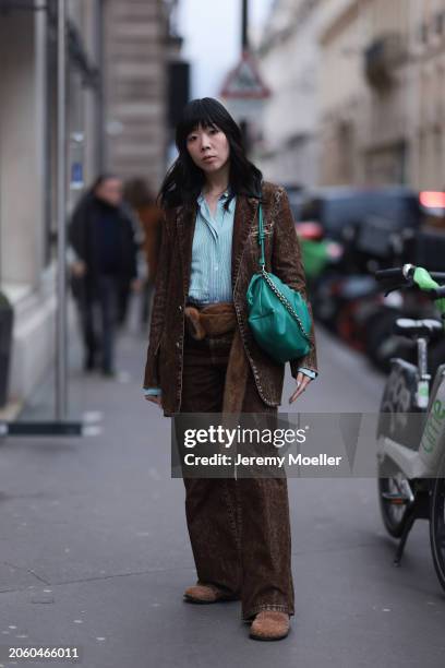 Susie Lau seen wearing green / white striped buttoned shirt, brown denim blazer jacket, matching brown denim / jeans wide leg pants, brown fluffy...