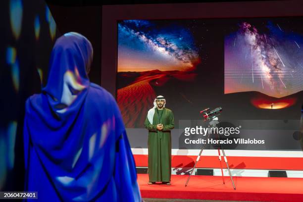 Woman wearing a traditional dress listens to the presentation on astrophotography by photographer Yusuf Al Qasimi, member of the Emirates...