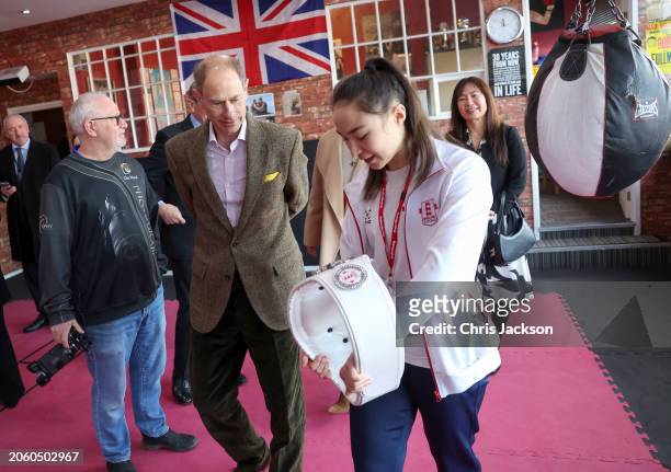 Prince Edward, Duke of Edinburgh is shown the Championship Belt by National Youth Champion Amy Nolan at the Right Stuff Amateur Boxing Club during...