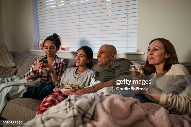 family time in the living room - family in front of tv stock pictures, royalty-free photos & images