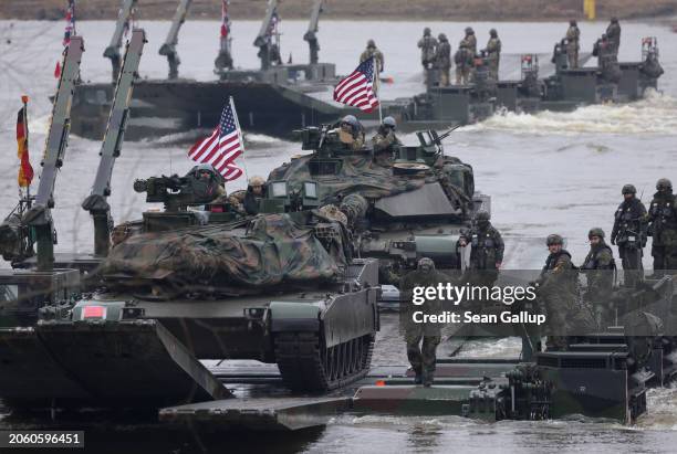Abrams main battle tanks of the U.S. Army ride on M3 amphibious rigs of the German/British Amphibious Engineer Battalion 130 while crossing the...