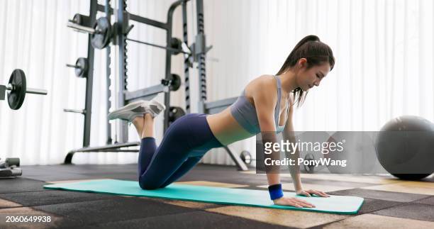 asian female aerobics at gym - push up japanese stock-fotos und bilder