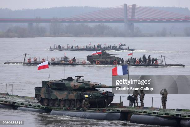 Polish Leopard 2PL main battle tank arrives on a French military ferry while crossing the Vistula River during the NATO Dragon 24 military exercise...