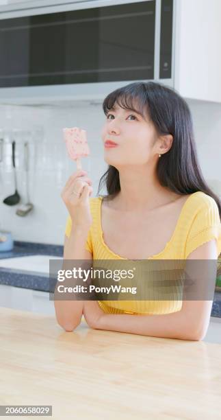 asian woman enjoying ice stick - holding popsicle stick stock pictures, royalty-free photos & images