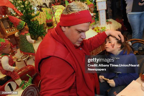 Natalie Myers, age 5 of Schuylerville, gets a raindeer painted on her face by P.J. Duell at the Victorian Streetwalk in Saratoga Springs, NY on...