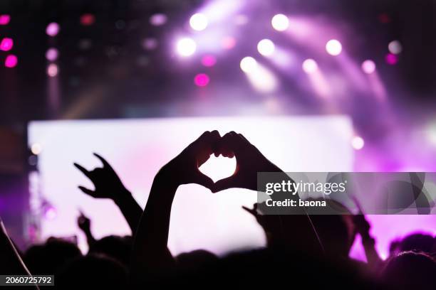hands making heart shape at music festival - hand heart stock pictures, royalty-free photos & images