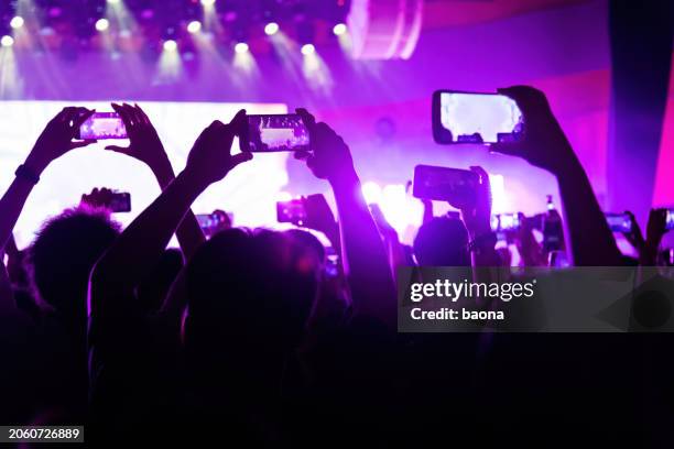 people taking picture at music festival - shooting hand stock pictures, royalty-free photos & images