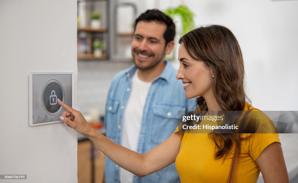 Couple leaving their smart home and locking the house using a security system