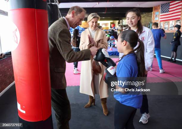 Prince Edward, Duke of Edinburgh fist bumps Lacey Douglas, aged 11, as Sophie, Duchess of Edinburgh claps with National Youth Champion Amy Nolan at...