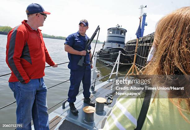 Mike Kozloski, BM1 Coastguard, explains the M16 rifle aboard the U.S. Coast Guard Cutter Sailfish at the Port of Albany in Albany, NY on May 14,...