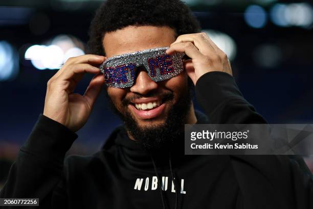 Caleb Williams #QB14 of Southern California smiles while wearing “Draft Me” sunglasses during the NFL Combine at the Indiana Convention Center on...