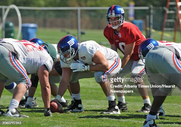 New York Giants football player Adam Koets hikes the ball to quarterback Eli Manning during a drill at training camp at UAlbany in Albany, NY on...