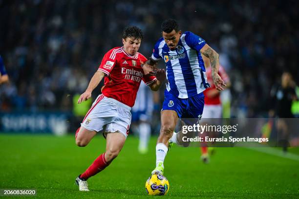 João Neves of Benfica fights for the ball with Wenderson Galeno of FC Porto during the Liga Portugal Betclic match between FC Porto and SL Benfica at...